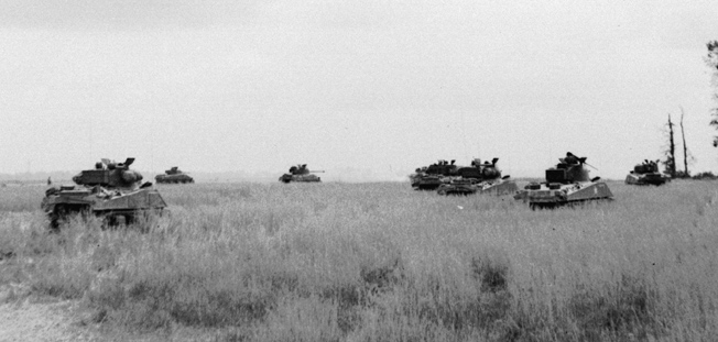 British armoured units were well equipped with U.S. M4 Sherman tanks, shown here crossing an open wheat field in the Odon Valley near Evrecy, July 16.
