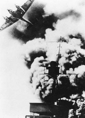 A German Me-110 fighter streaks over a smoking German destroyer during the intense fighting in April 1940.